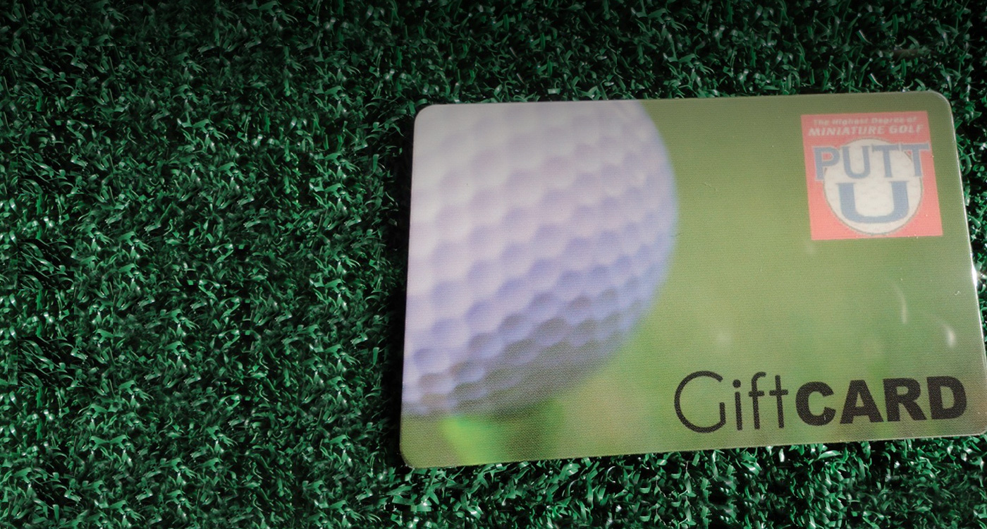 A Putt U gift card on an artificial turf putting green